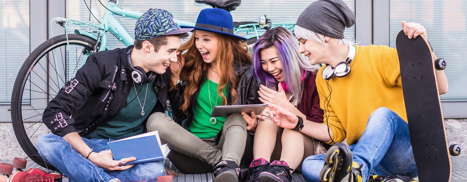 young adults hanging out watching tablet young adults hanging out watching tablet